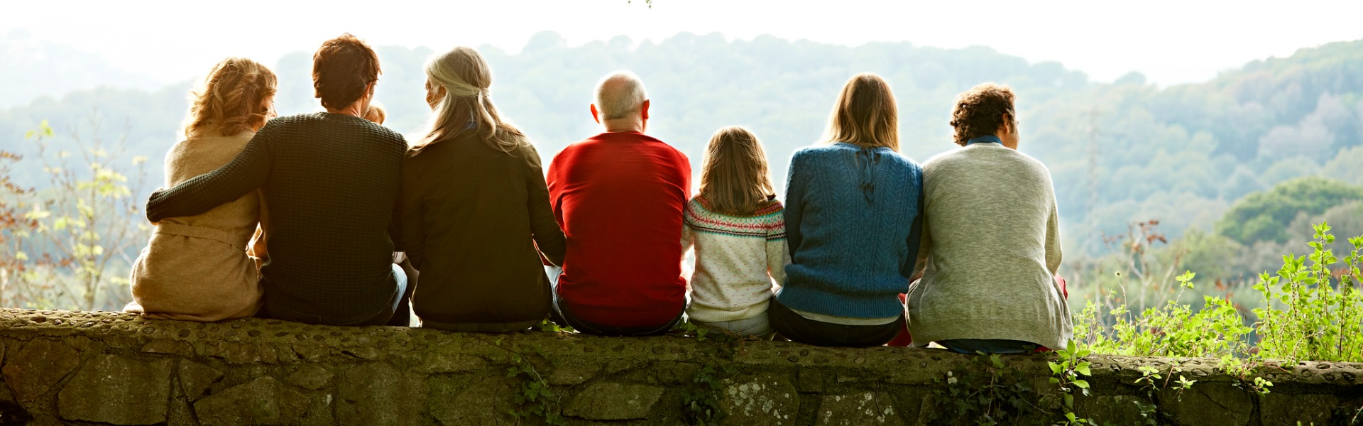 Family sitting on a stone wall